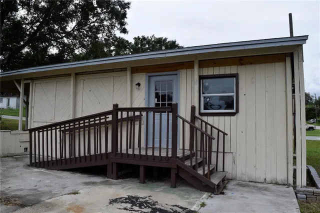 a view of a house with a wooden deck