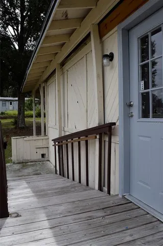 a view of a balcony with floor to ceiling windows yard and outdoor view