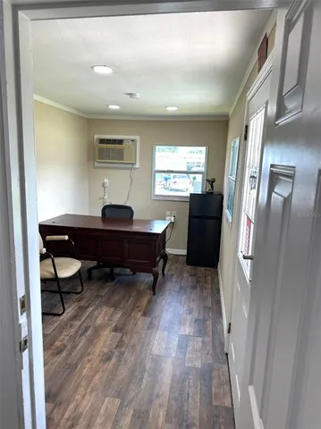a view of a room with wooden floor and windows