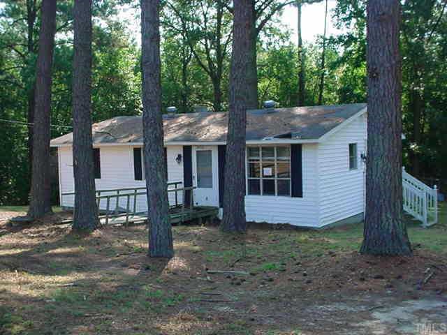 9755 Lake Royalle Road Spring Hope, NC 27882 - Photo 1 of 1 a view of house with a yard and large trees