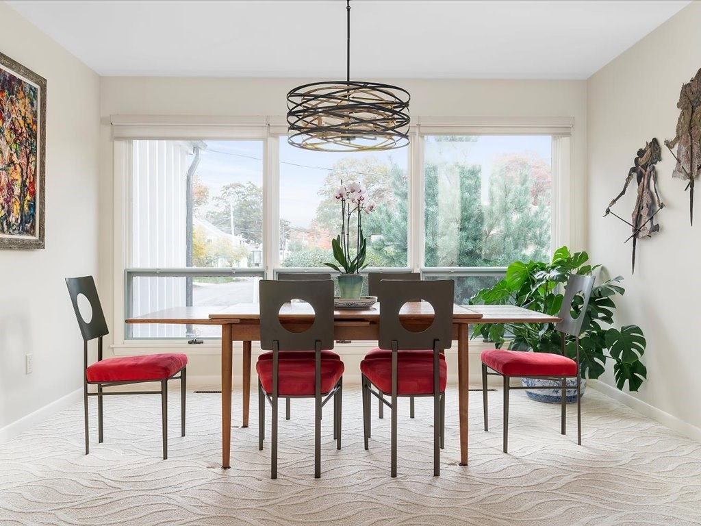447 Albany Street Fall River, MA 02720 - Photo 14 of 33 a dining room with furniture potted plants and wooden floor