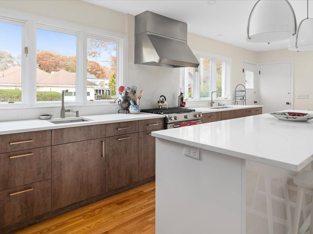 447 Albany Street Fall River, MA 02720 - Photo 21 of 33 a kitchen with a sink a window and cabinets
