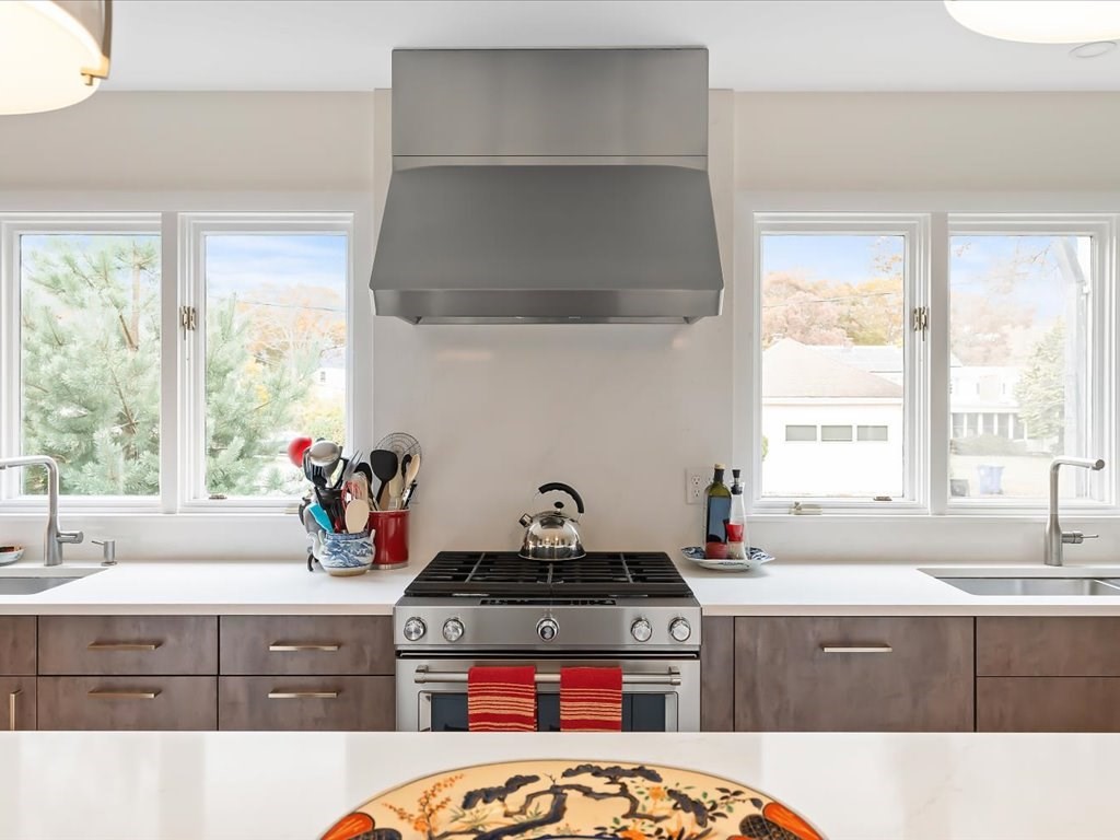 447 Albany Street Fall River, MA 02720 - Photo 22 of 33 a kitchen with a stove a sink and a window