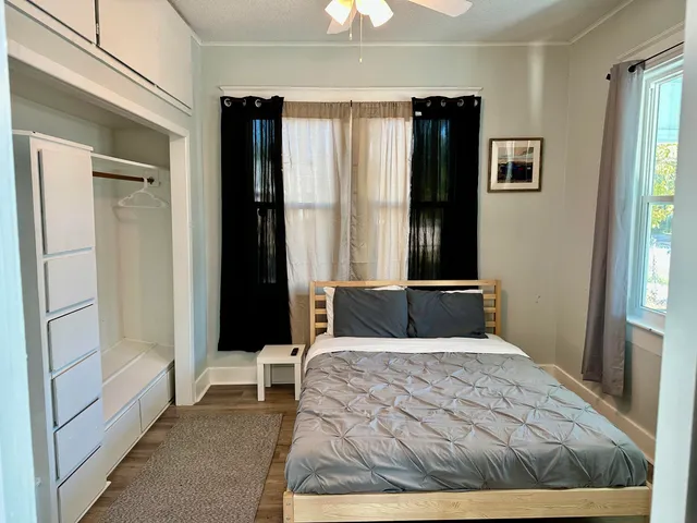 a bedroom with a bed and a chandelier