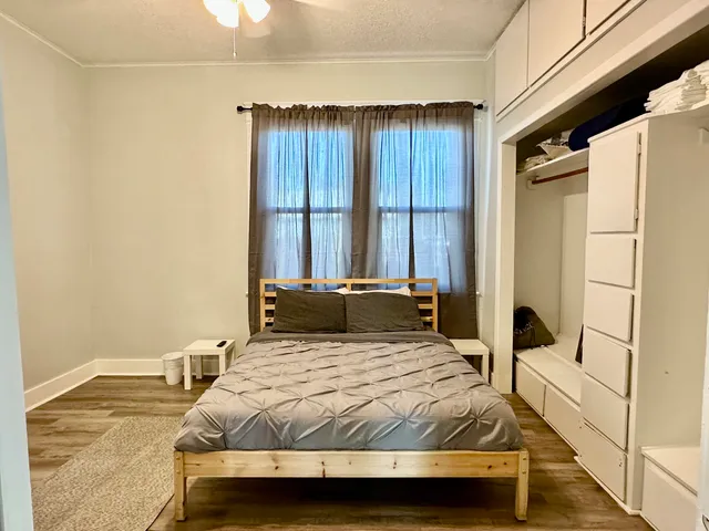 a bedroom with a bed and a dresser