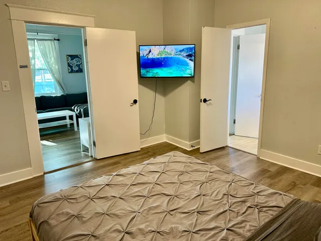 a view of a room with wooden floor and cabinet