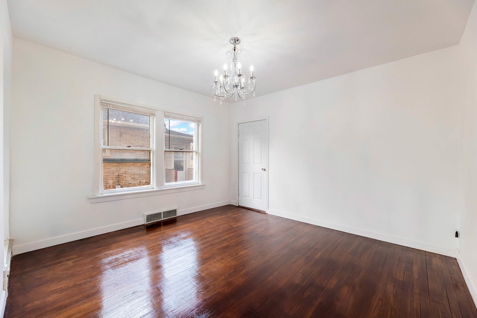 1908 South 23rd Avenue Maywood, IL 60153 - Photo 11 of 37 a view of an empty room with wooden floor and a window