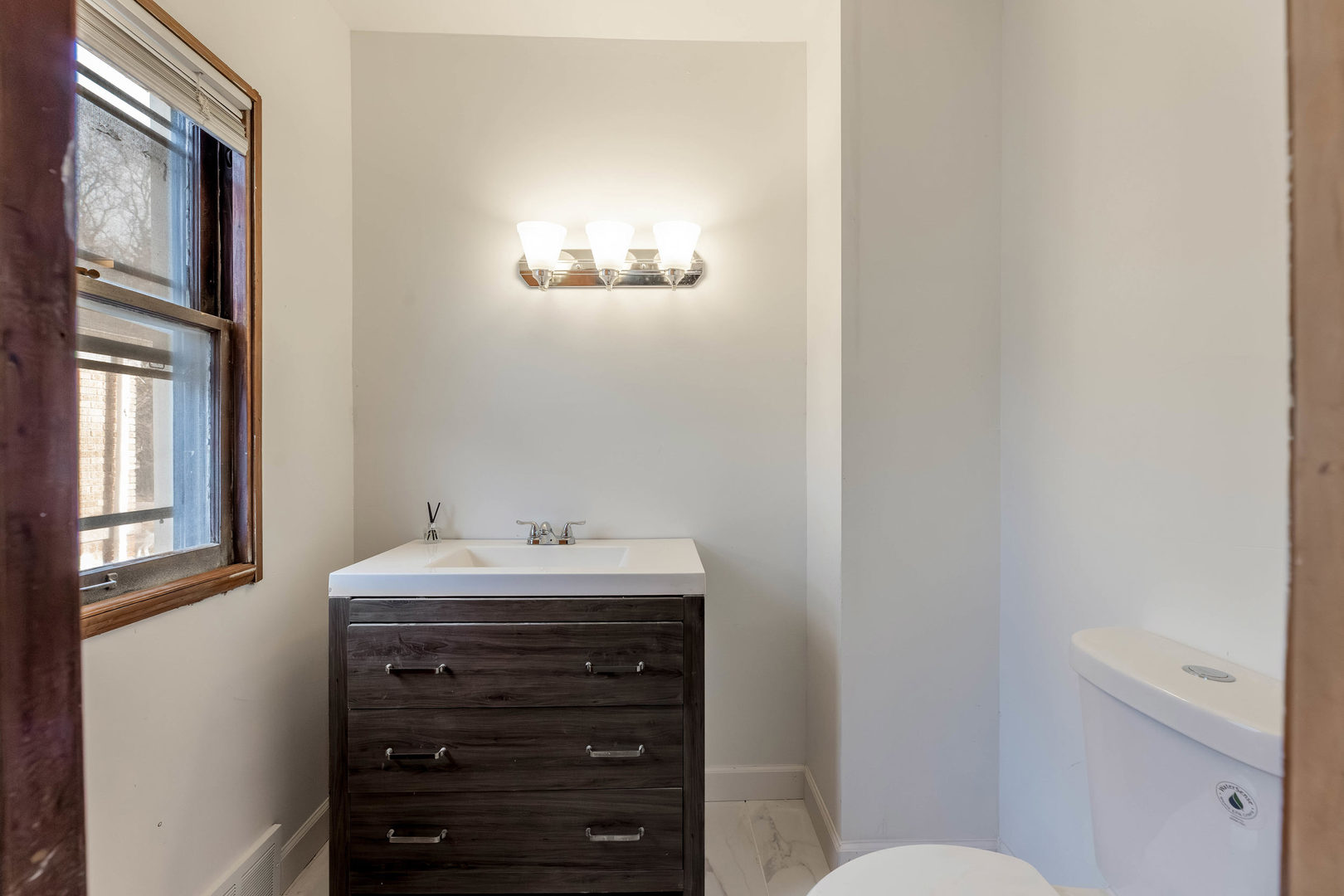 1908 South 23rd Avenue Maywood, IL 60153 - Photo 14 of 37 a bathroom with a sink a toilet and mirror