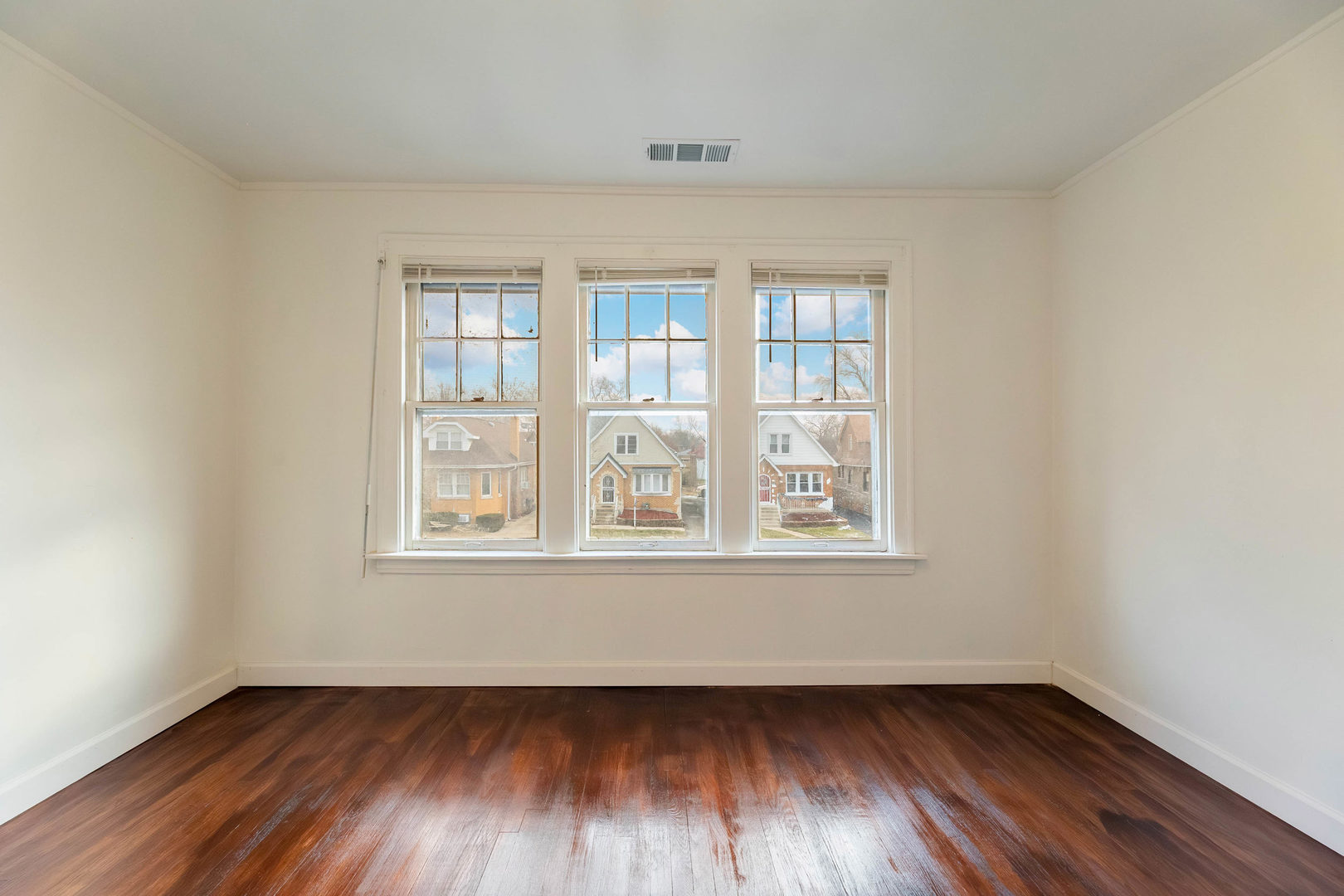 1908 South 23rd Avenue Maywood, IL 60153 - Photo 15 of 37 an empty room with wooden floor and windows
