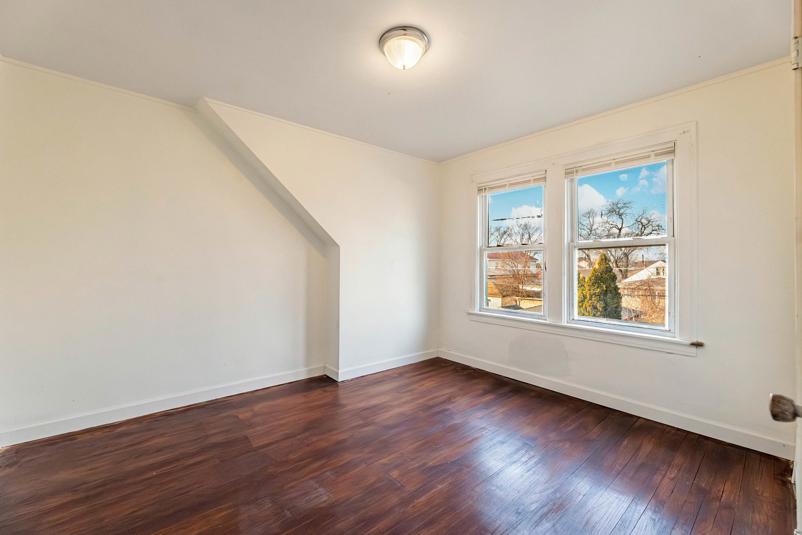 1908 South 23rd Avenue Maywood, IL 60153 - Photo 18 of 37 a view of an empty room with wooden floor and a window