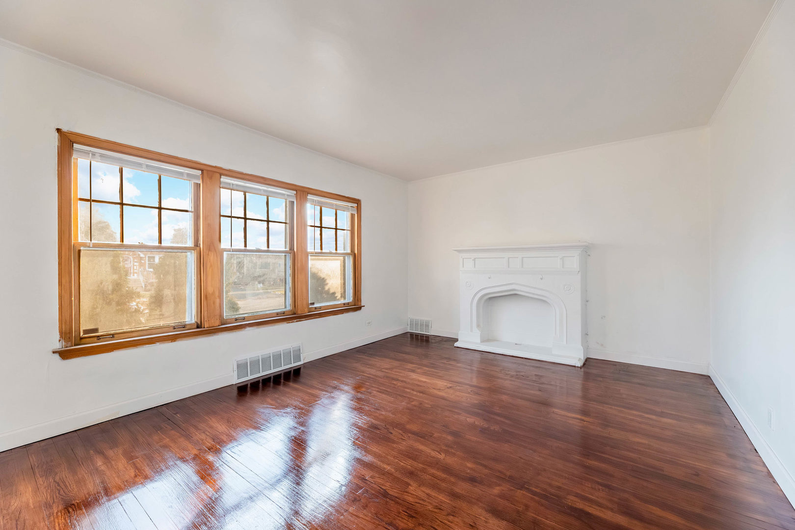 1908 South 23rd Avenue Maywood, IL 60153 - Photo 2 of 37 an empty room with wooden floor and windows