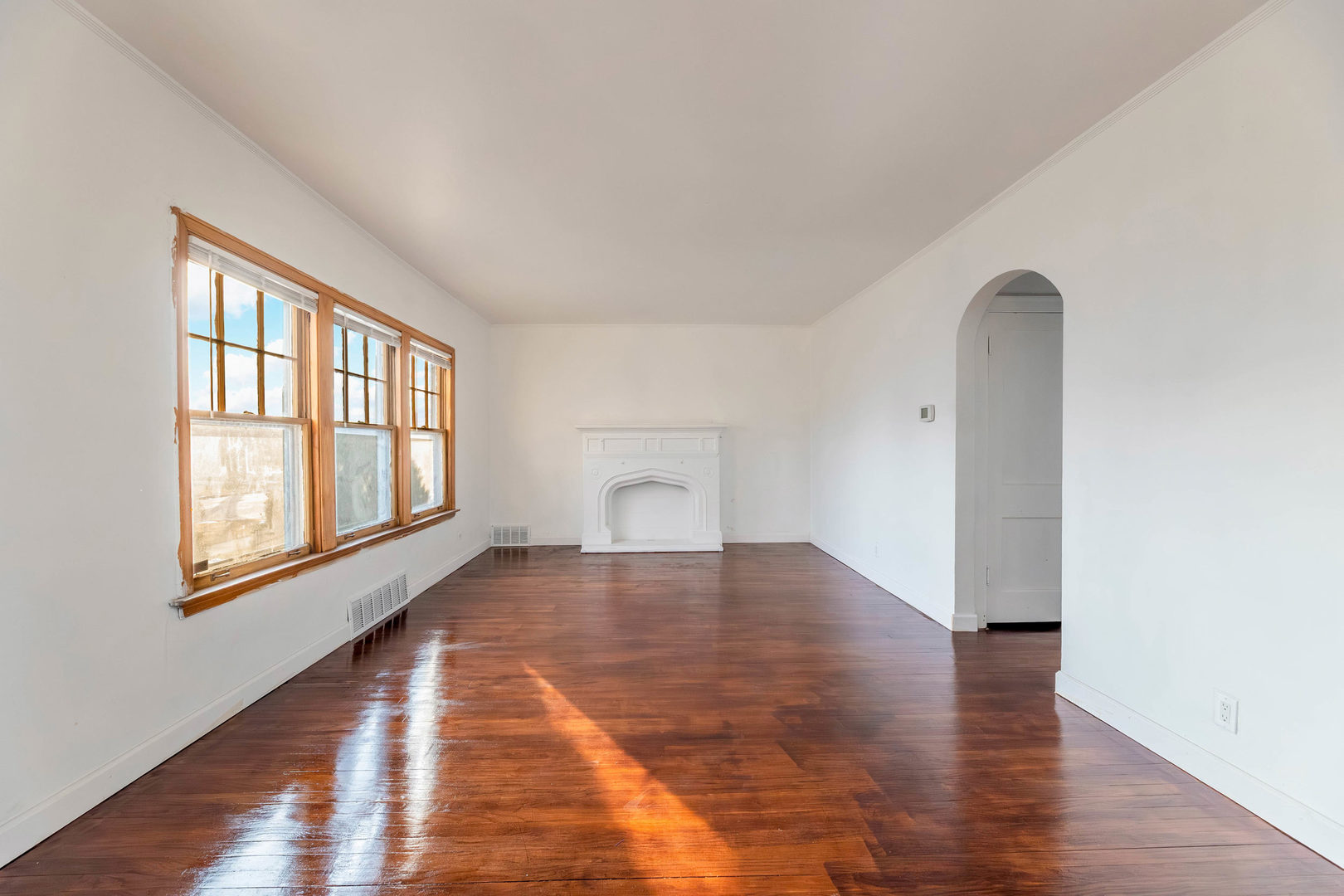 1908 South 23rd Avenue Maywood, IL 60153 - Photo 4 of 37 an empty room with wooden floor and windows