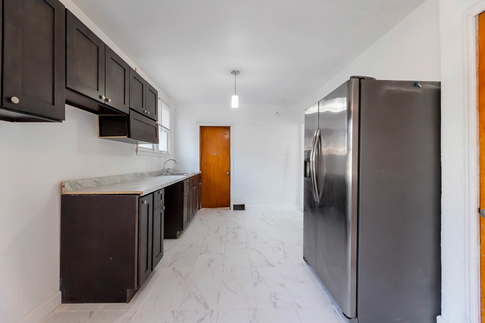 1908 South 23rd Avenue Maywood, IL 60153 - Photo 9 of 37 a kitchen with stainless steel appliances granite countertop a refrigerator and a sink