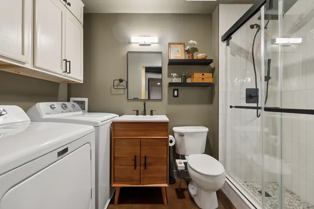 a bathroom with a sink toilet and shower