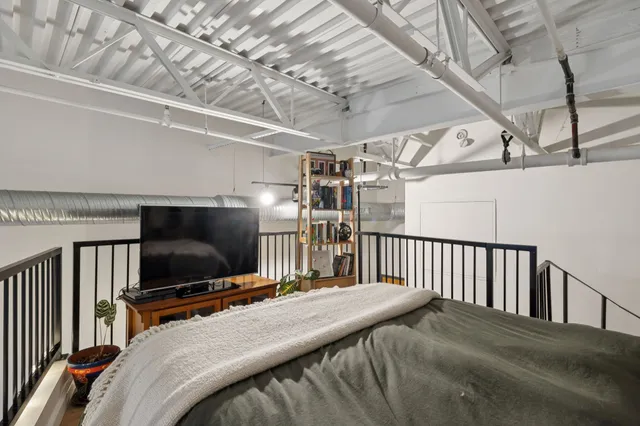 a bedroom with a bed and a flat screen tv