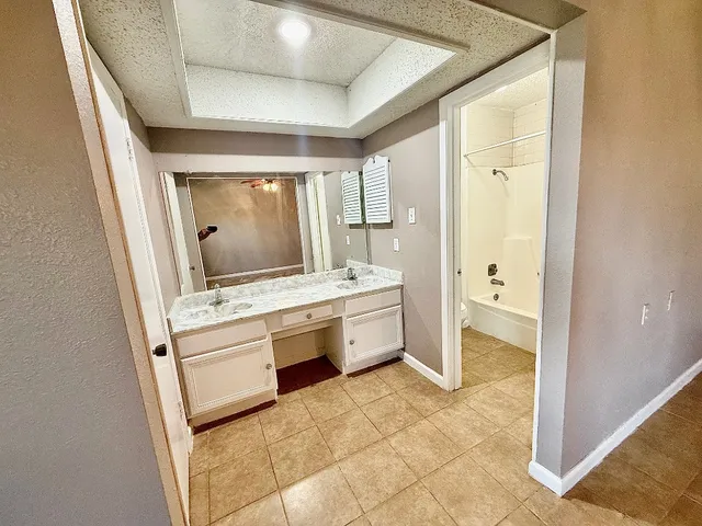 a bathroom with a sink a vanity and mirror