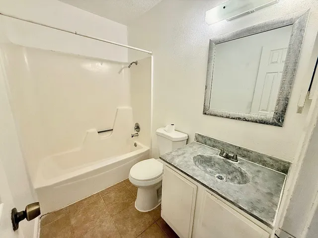 a bathroom with a sink a toilet and a bathtub