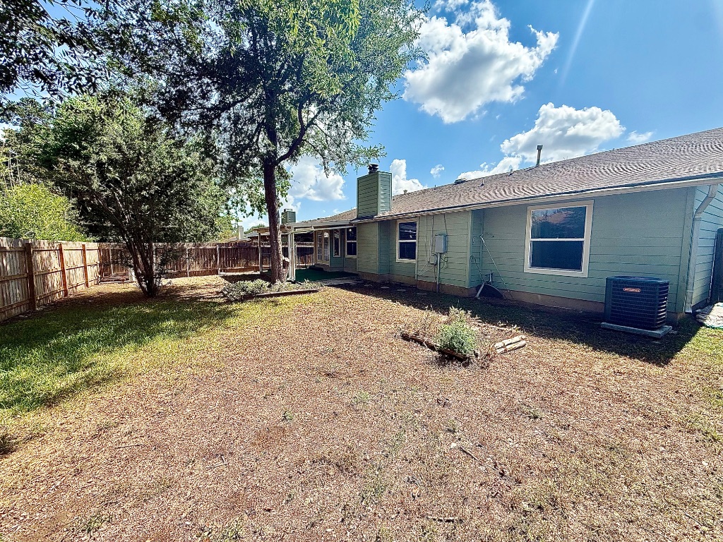 12102 Grey Fawn Path Austin, TX 78750 - Photo 23 of 24 a backyard of a house with table and chairs