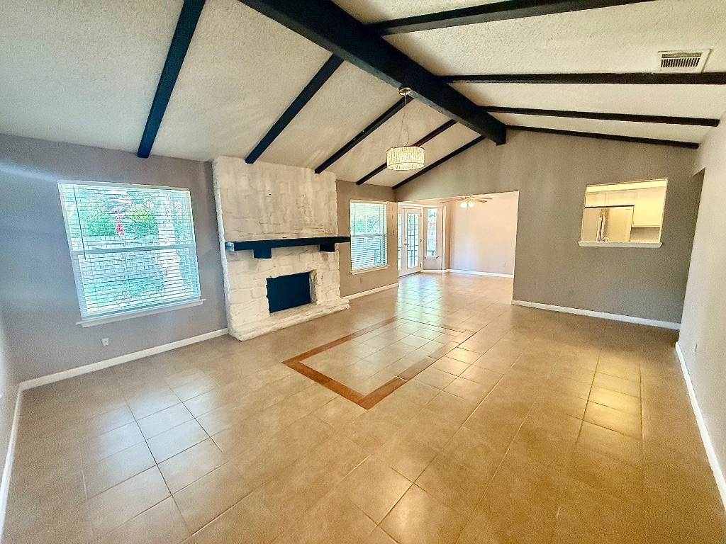 12102 Grey Fawn Path Austin, TX 78750 - Photo 4 of 24 a view of an empty room with a fireplace and a window