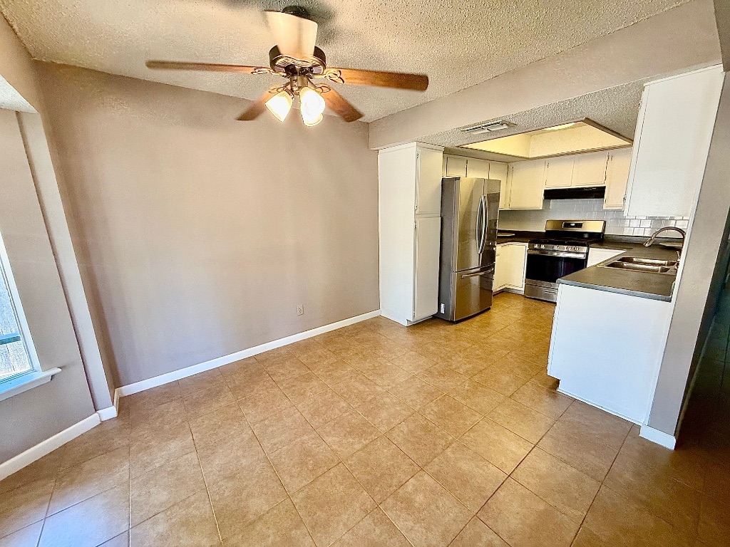 12102 Grey Fawn Path Austin, TX 78750 - Photo 7 of 24 a view of a kitchen with a sink
