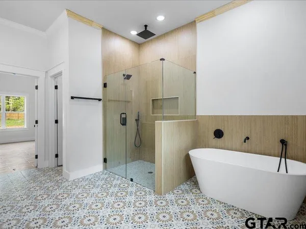 a bathroom with a bathtub and a shower