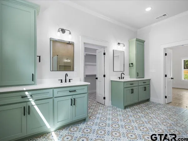 a spacious bathroom with a granite countertop sink mirror and bathtub