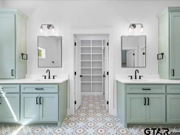 a spacious bathroom with a sink and a mirror
