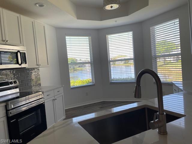 3610 Lansing Loop, Unit 103 Estero, FL 33928 - Photo 22 of 33 Newly painted cabinets, quartz counters, SS sink.