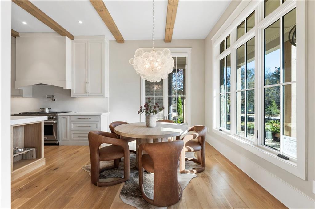 1000 Haddie Way Alpharetta, GA 30004 - Photo 16 of 95 a dining room with furniture a chandelier and wooden floor