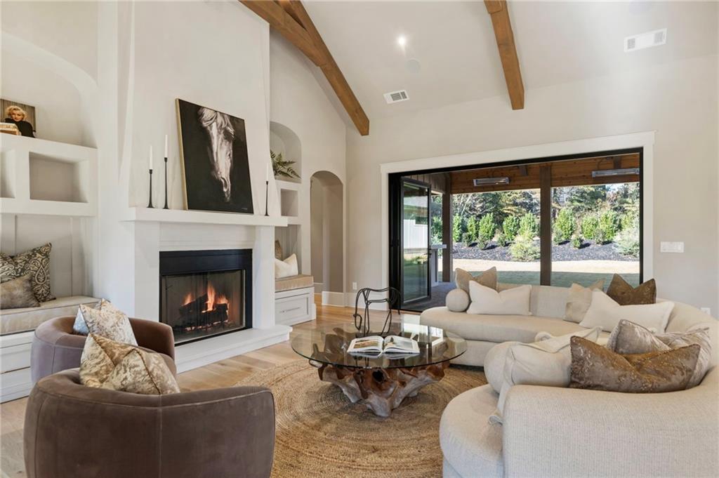 1000 Haddie Way Alpharetta, GA 30004 - Photo 37 of 95 a living room with furniture large window and a fireplace