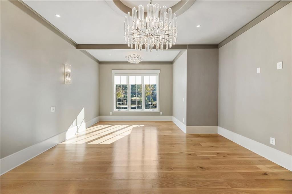 1000 Haddie Way Alpharetta, GA 30004 - Photo 55 of 95 a view of an empty room with wooden floor and a chandelier