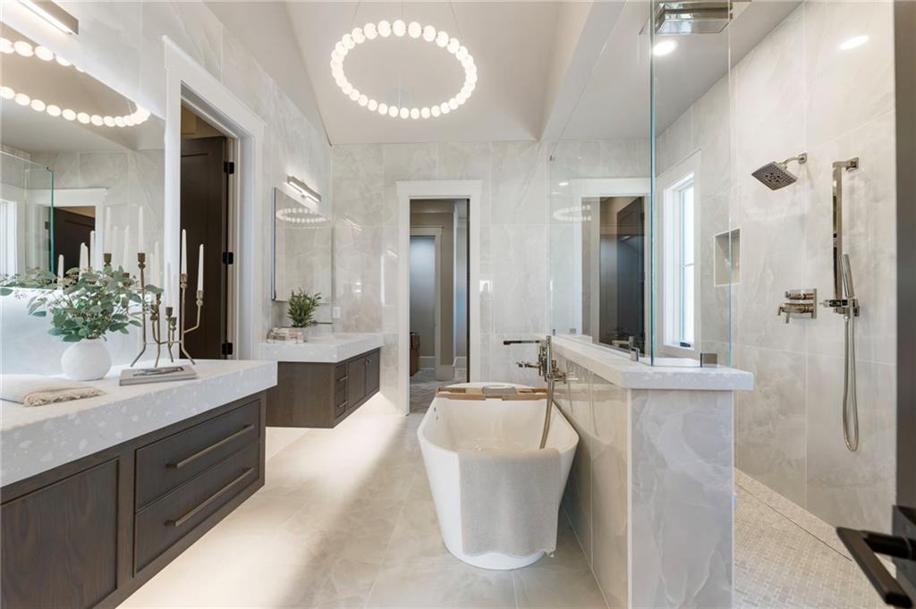 1000 Haddie Way Alpharetta, GA 30004 - Photo 56 of 95 a spacious bathroom with a bathtub sink and mirror