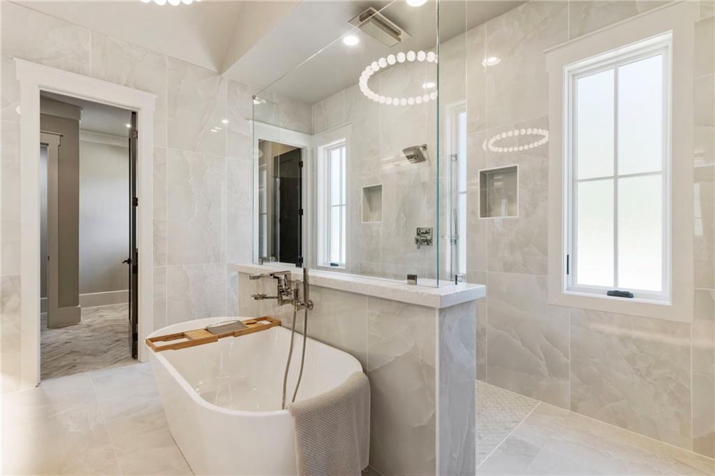 1000 Haddie Way Alpharetta, GA 30004 - Photo 60 of 95 a bathroom with a tub a sink and a large mirror