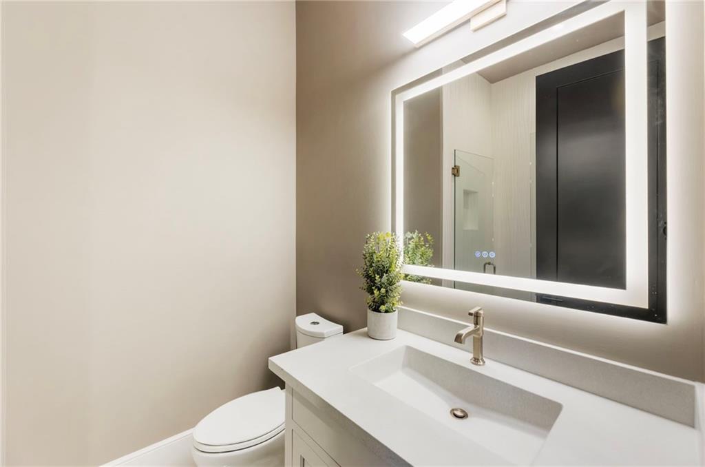 1000 Haddie Way Alpharetta, GA 30004 - Photo 75 of 95 a bathroom with a sink a toilet and mirror