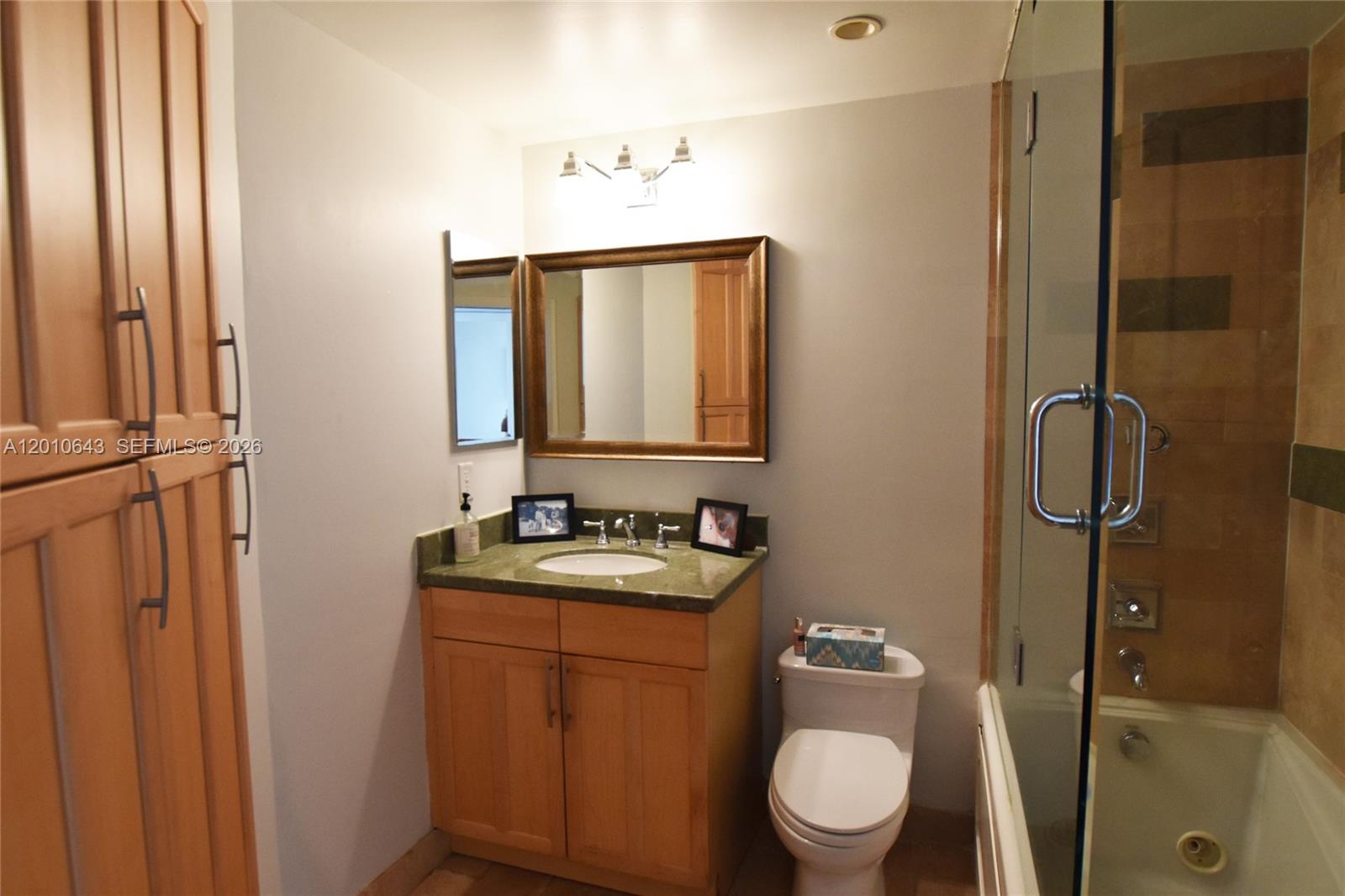 540 Brickell Key Drive, Unit PH1812 Miami, FL 33131 - Photo 11 of 29 a bathroom with a toilet sink and mirror
