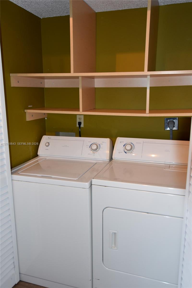 540 Brickell Key Drive, Unit PH1812 Miami, FL 33131 - Photo 12 of 29 a utility room with dryer and washer