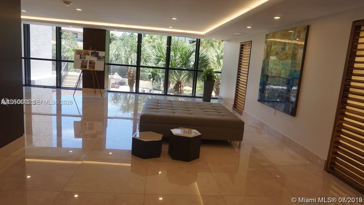 540 Brickell Key Drive, Unit PH1812 Miami, FL 33131 - Photo 16 of 29 a living room with glass door and furniture