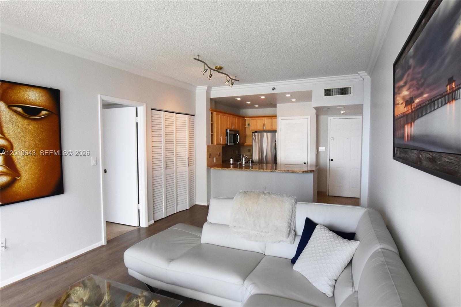 540 Brickell Key Drive, Unit PH1812 Miami, FL 33131 - Photo 3 of 29 a living room with furniture and a flat screen tv