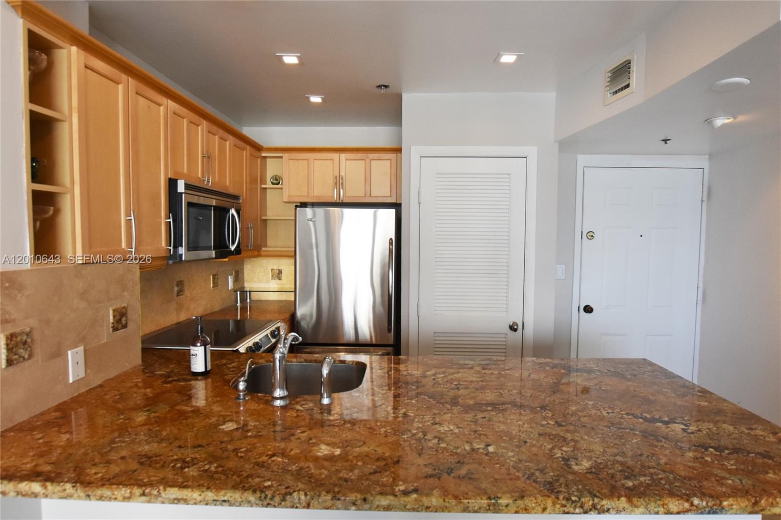 540 Brickell Key Drive, Unit PH1812 Miami, FL 33131 - Photo 6 of 29 a kitchen with a refrigerator and a sink