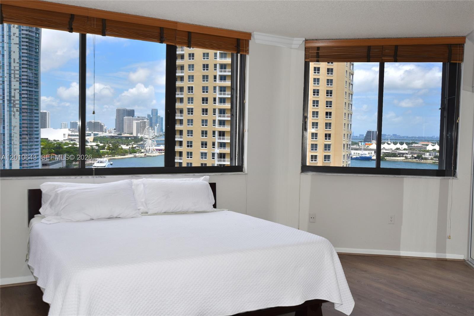 540 Brickell Key Drive, Unit PH1812 Miami, FL 33131 - Photo 7 of 29 a bedroom with a large window and a bed