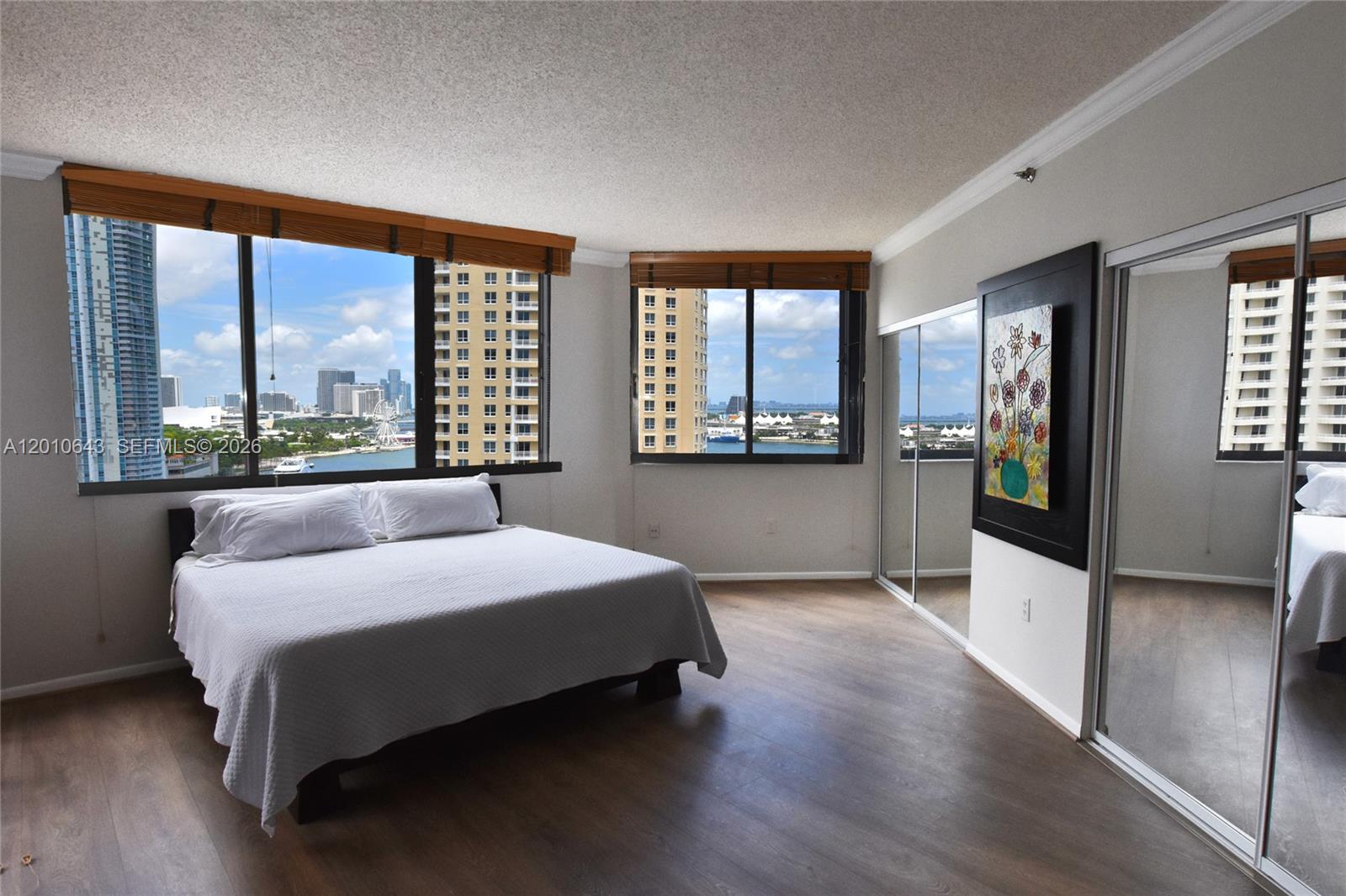 540 Brickell Key Drive, Unit PH1812 Miami, FL 33131 - Photo 8 of 29 a bedroom with a large bed and a large window