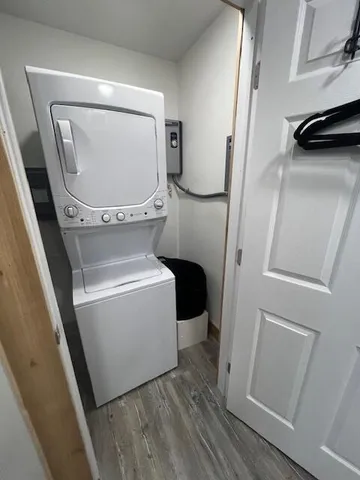 a utility room with wooden floor washer and dryer