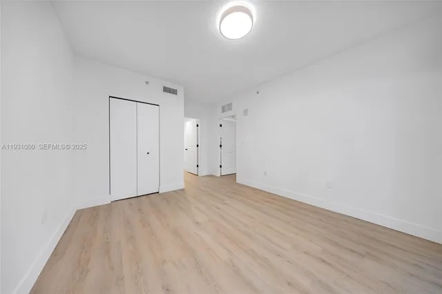 a view of walk in closet with empty racks