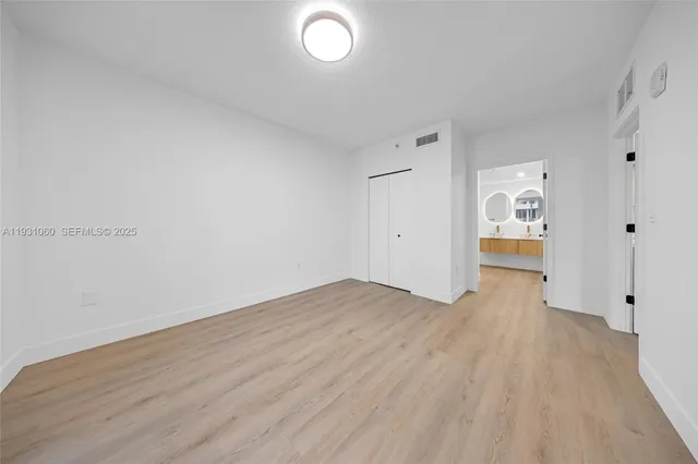 a view of wooden floor and windows in a room