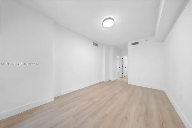 a living room with furniture and kitchen tables