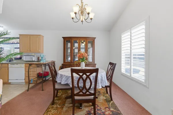 a view of a dining room with furniture and a window