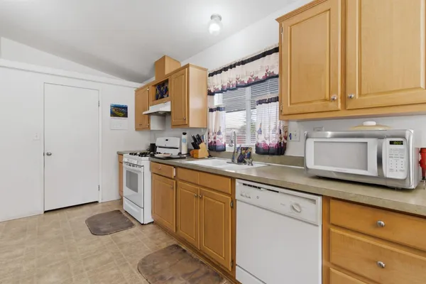 a kitchen with stainless steel appliances granite countertop a sink and cabinets