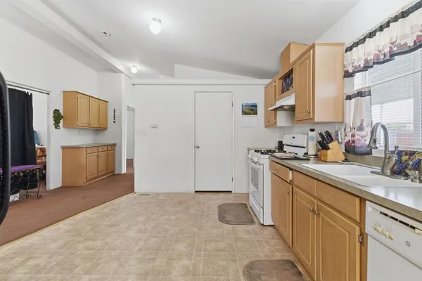 a kitchen with cabinets and a stove