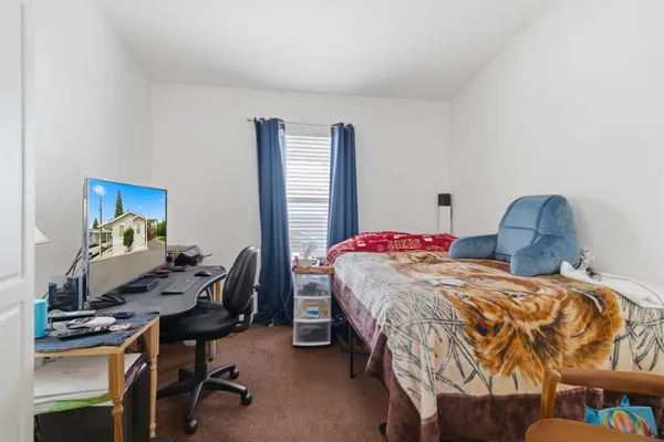 a bedroom with a bed and a desk