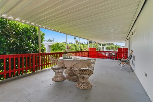 a backyard of a house with table and chairs